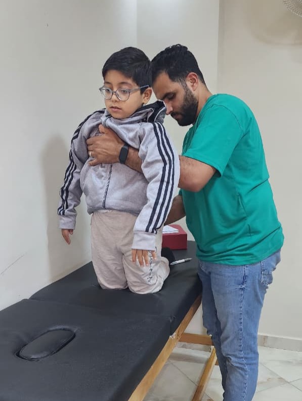 Haris receiving physiotherapy to regain mobility and independence."