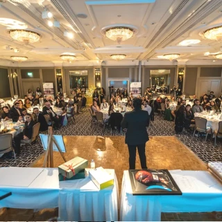 Speaker addressing guests at a Goodwill Caravan event