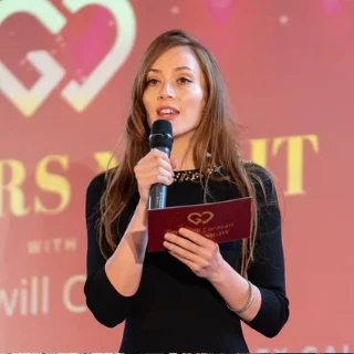 Host presenting on stage at the gala