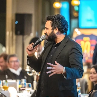 Guests seated at a Goodwill Caravan charity dinner